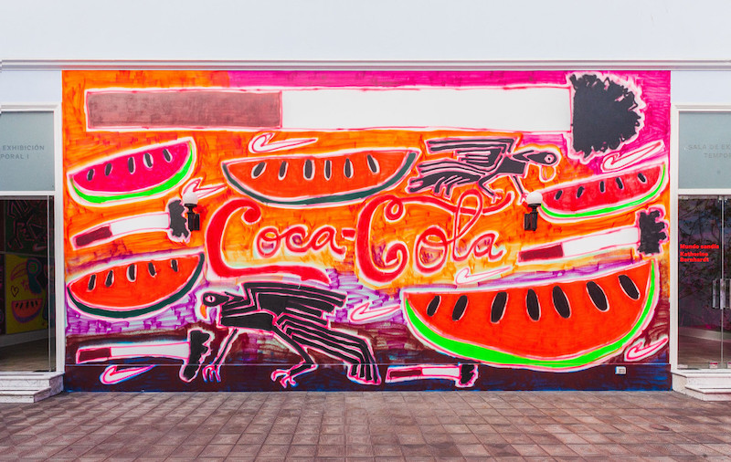 Katherine Bernhard mural gran escala con sandias Coca Cola, cuervo, logo NIKE y cigarrillos