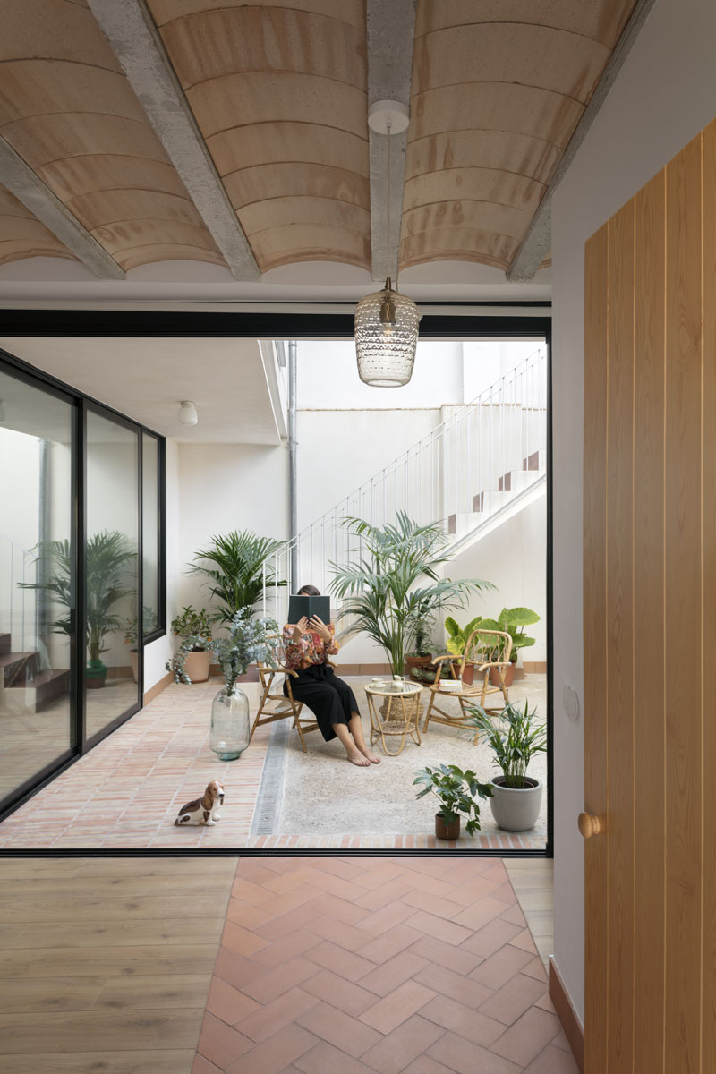 Jóvenes estudios arquitectura valencianos: casa con un patio central con muebles de mimbre