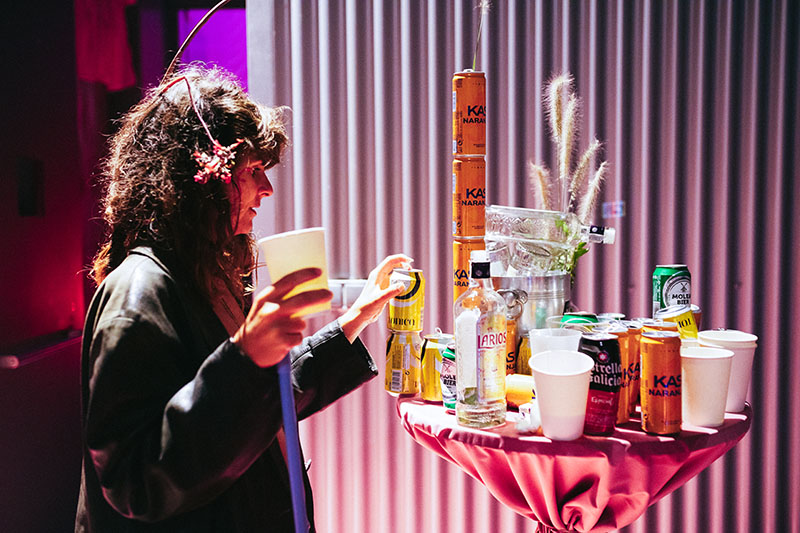La Inauguración de Joel Blanco en Torres Hejduk: una chica amontona basura en una mesa de bar