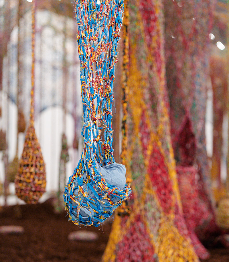 Ernesto Neto. Primer plano de la instalación con telas colgantes hechas de hilos de colorores.
