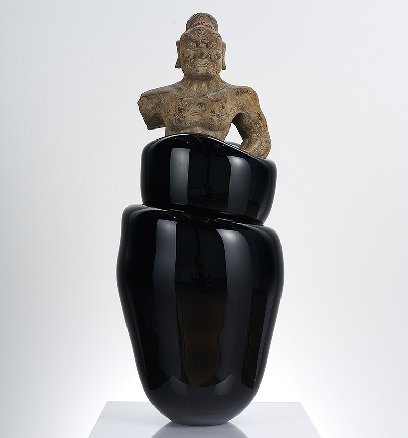 Escultura sagrada dentro de un recipiente de vidrio