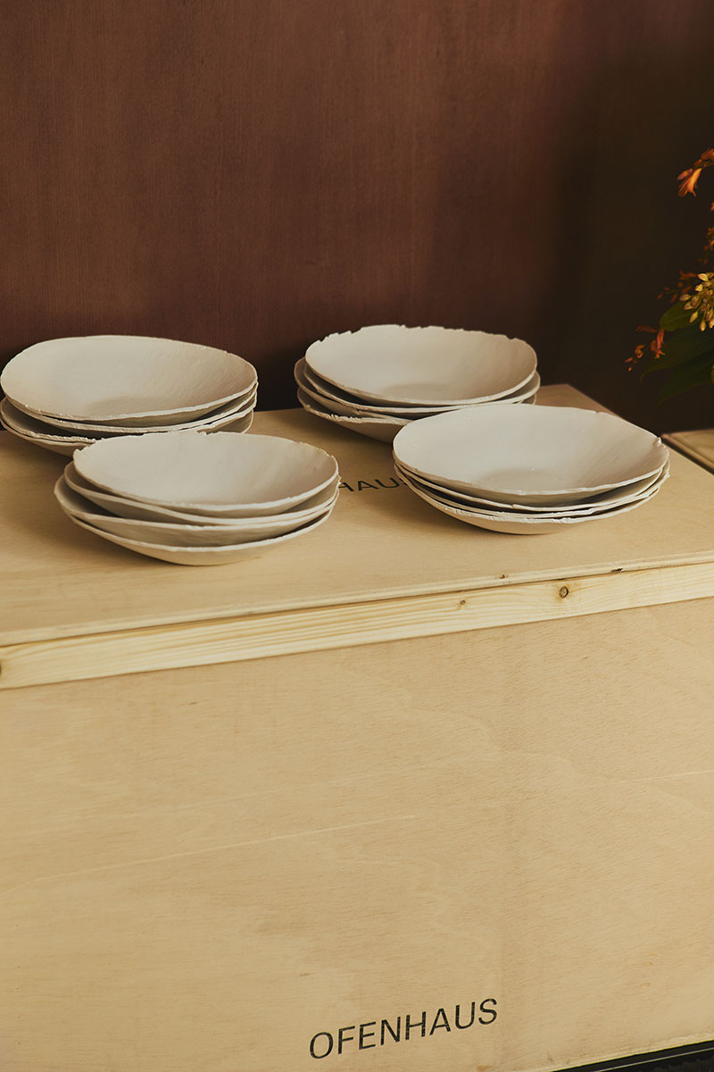 Conjunto de platos de Ofenhaus apilados sobre una caja de madera