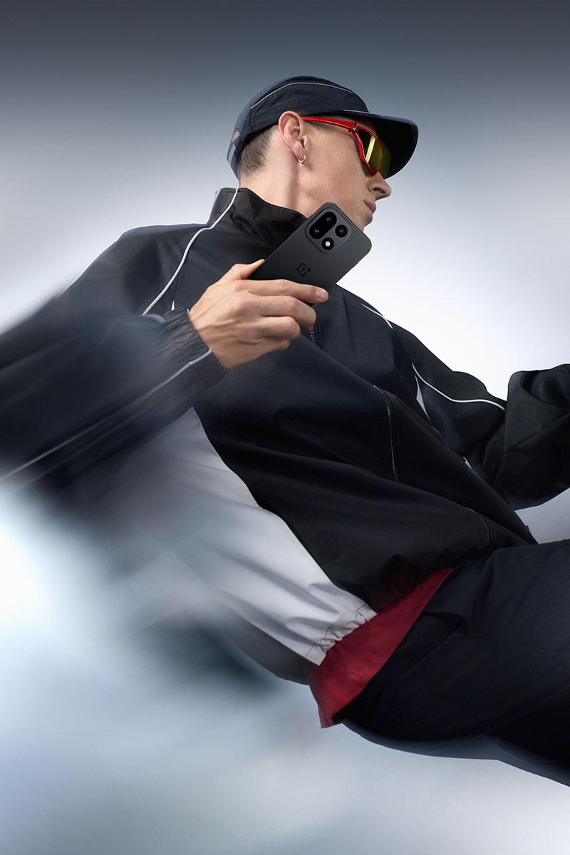 Las 10 diferencias entre el nuevo OnePlus 15 y su antecesor en OnePlus 13: un chico posa con el nuevo dispositivo