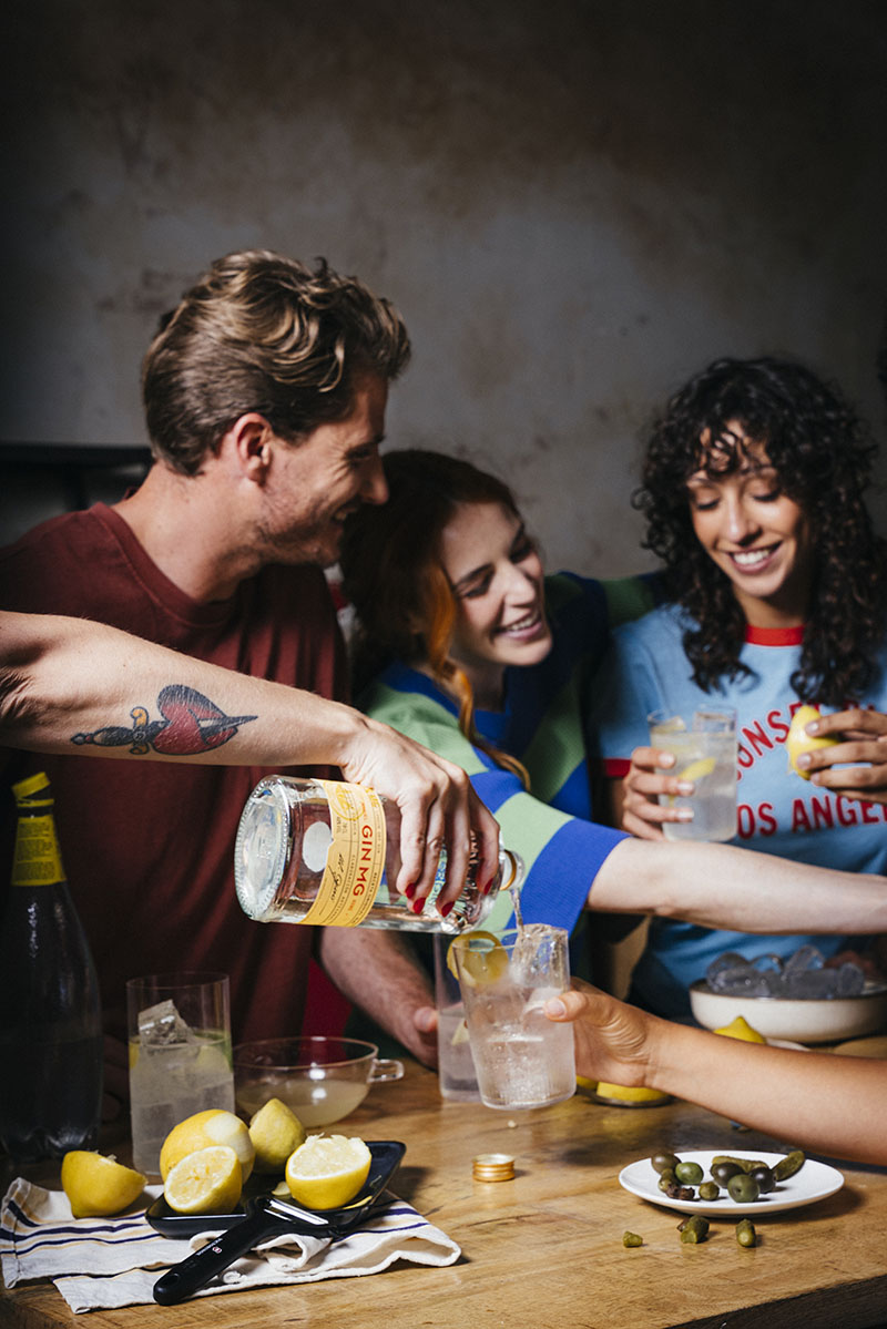 Personas disfrutando de GIN MG en una reunión organizada por el anfitrión